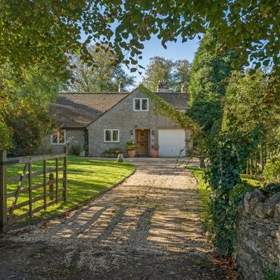 An open gate leads to a private country house with dry stone walls