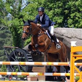 Ben Way jumps a fence during an equestrian show jumping competition