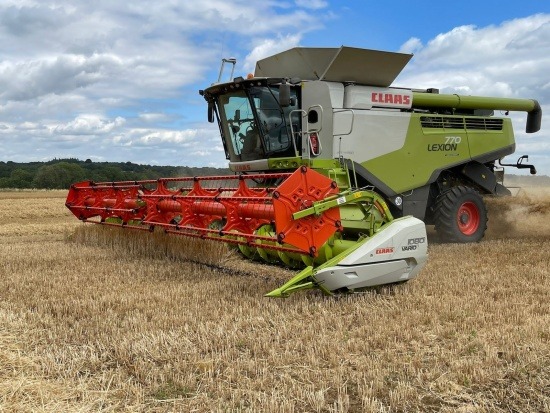 A combine harvester harvesting grain in the UK